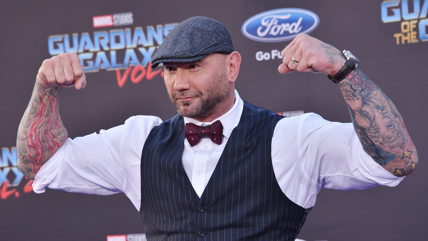 Dave Bautista at an event with several tattoos visible across his arms