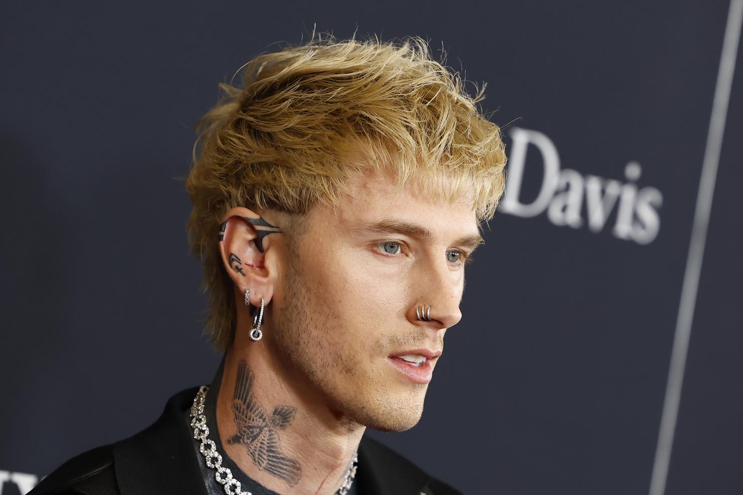 Machine Gun Kelly at the 2026 pre-Grammys event with new ink visible around his ears and the side of his face