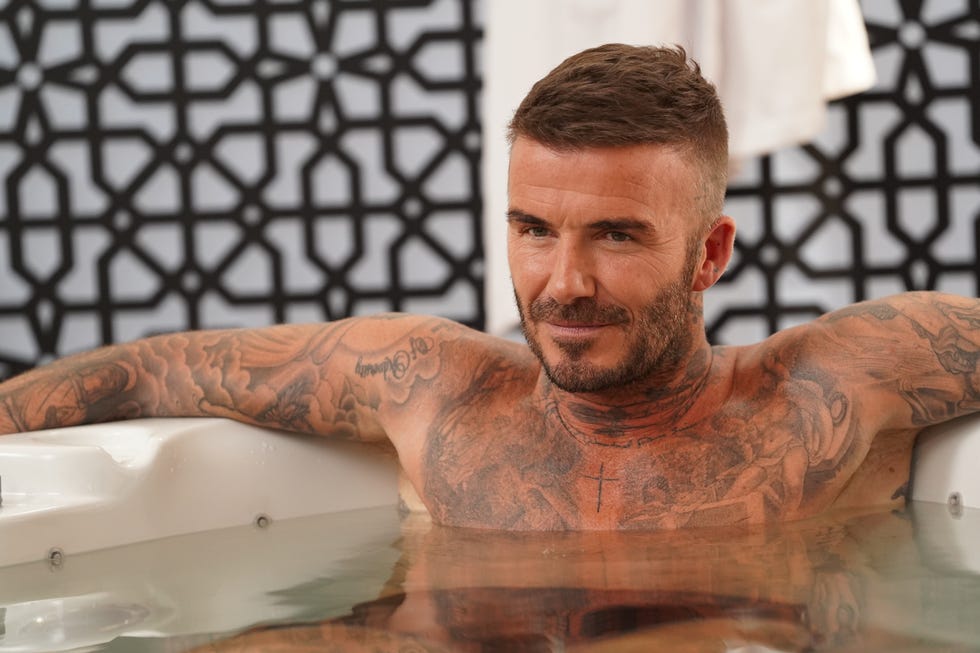 David Beckham displaying his chest and arm tattoos