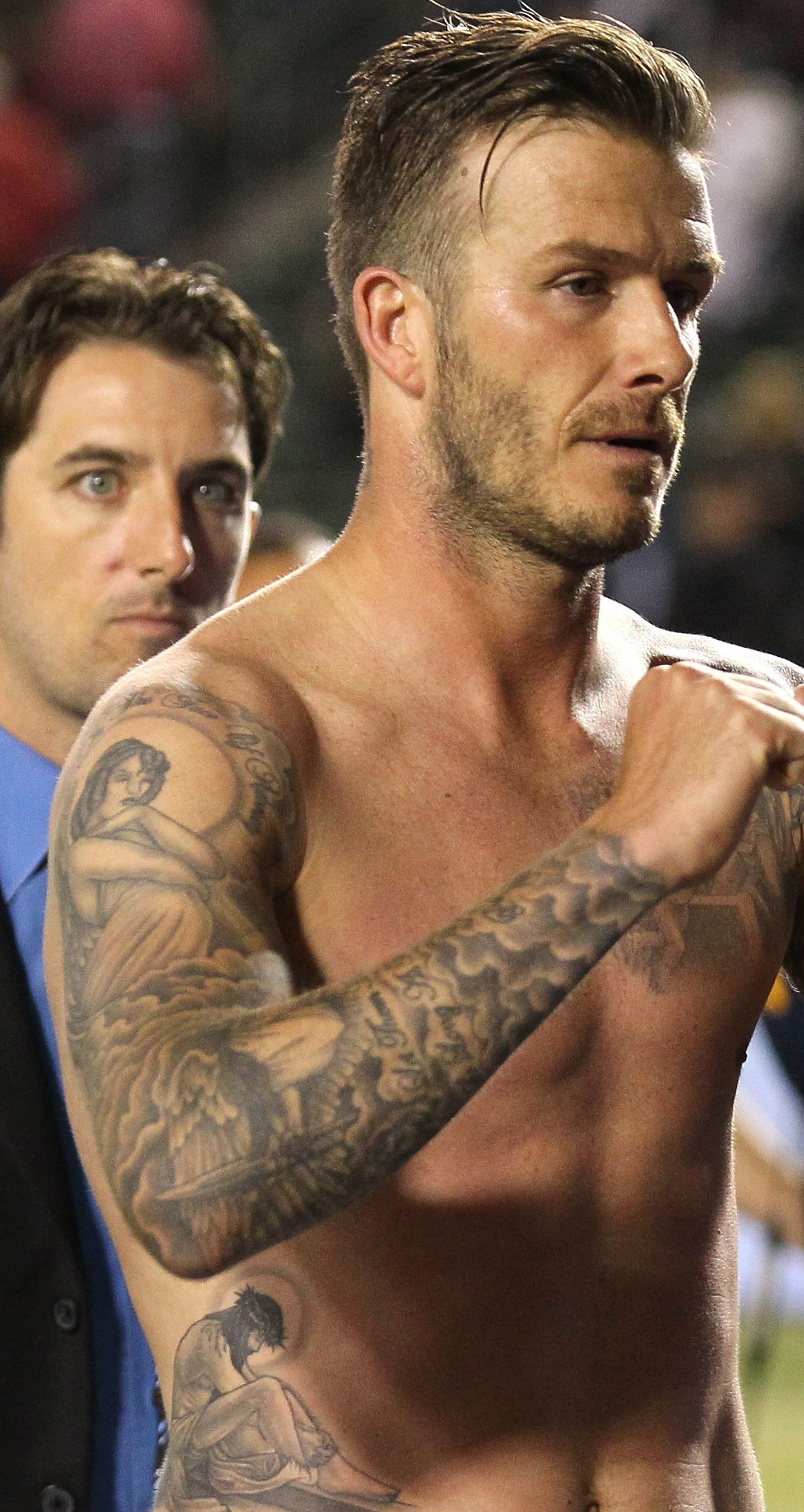 David Beckham’s tattooed arm sleeve with religious imagery and lettering