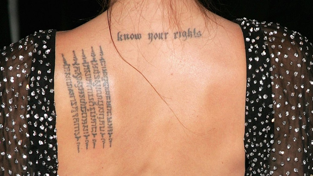 Angelina Jolie’s upper-back lettering tattoo reading Know Your Rights