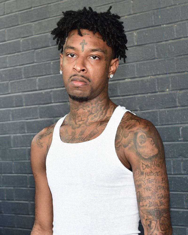 21 Savage showing the Dagger tattoo between his eyes