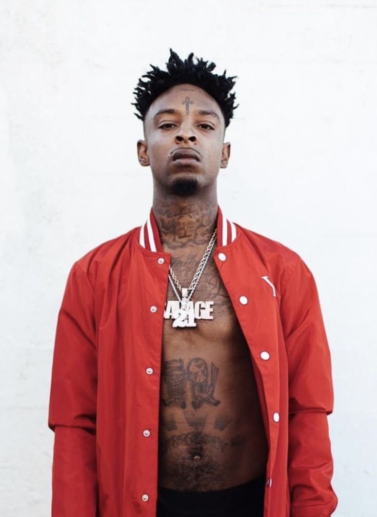 21 Savage showing the Forehead Cross and other face ink