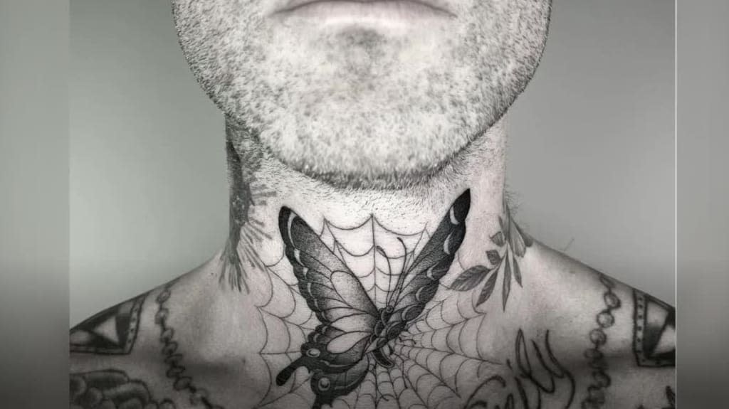 Adam Levine's butterfly caught in a spiderweb tattoo on the front of his neck