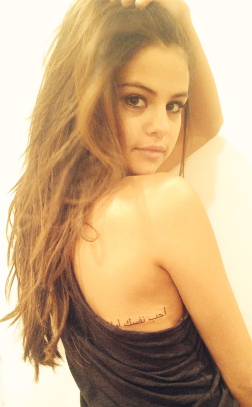 Selena Gomez’s Arabic script tattoo along her back and side