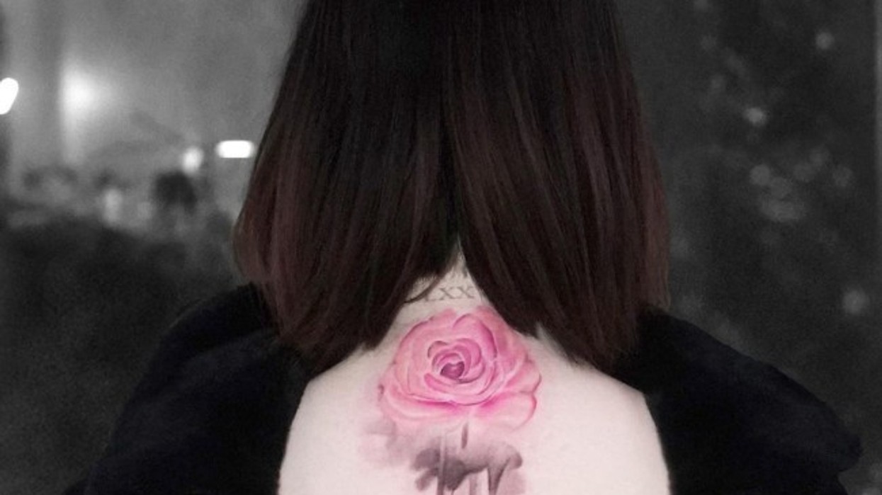Close view of Selena Gomez’s pink rose tattoo on her upper back