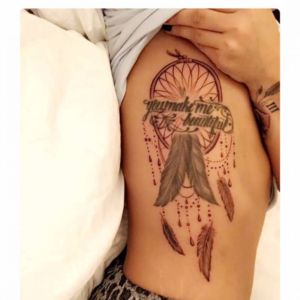 Demi Lovato’s rib tattoo with the words You Make Me Beautiful and its later dreamcatcher design
