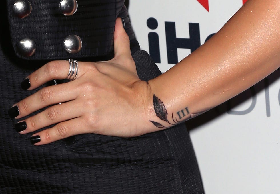 Demi Lovato’s Roman numeral III wrist tattoo beside a leaf design