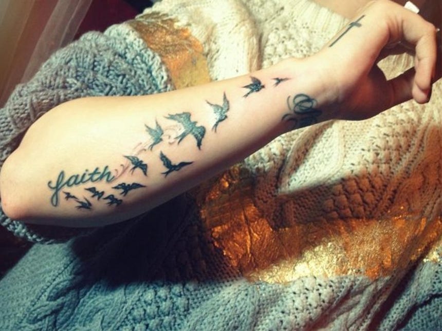 Demi Lovato’s faith lettering and flock of twelve birds tattooed by Kat Von D