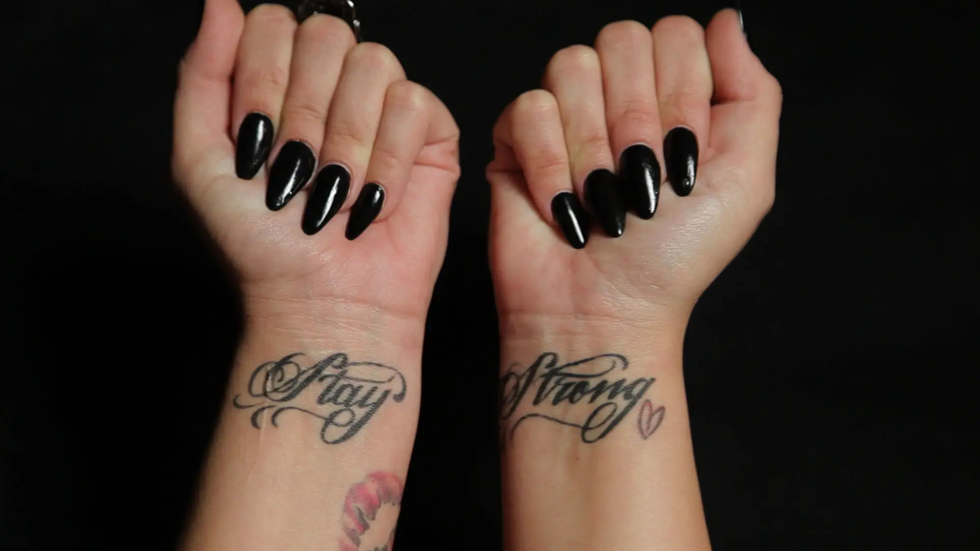 Demi Lovato’s separate Stay and Strong wrist tattoos with a small heart