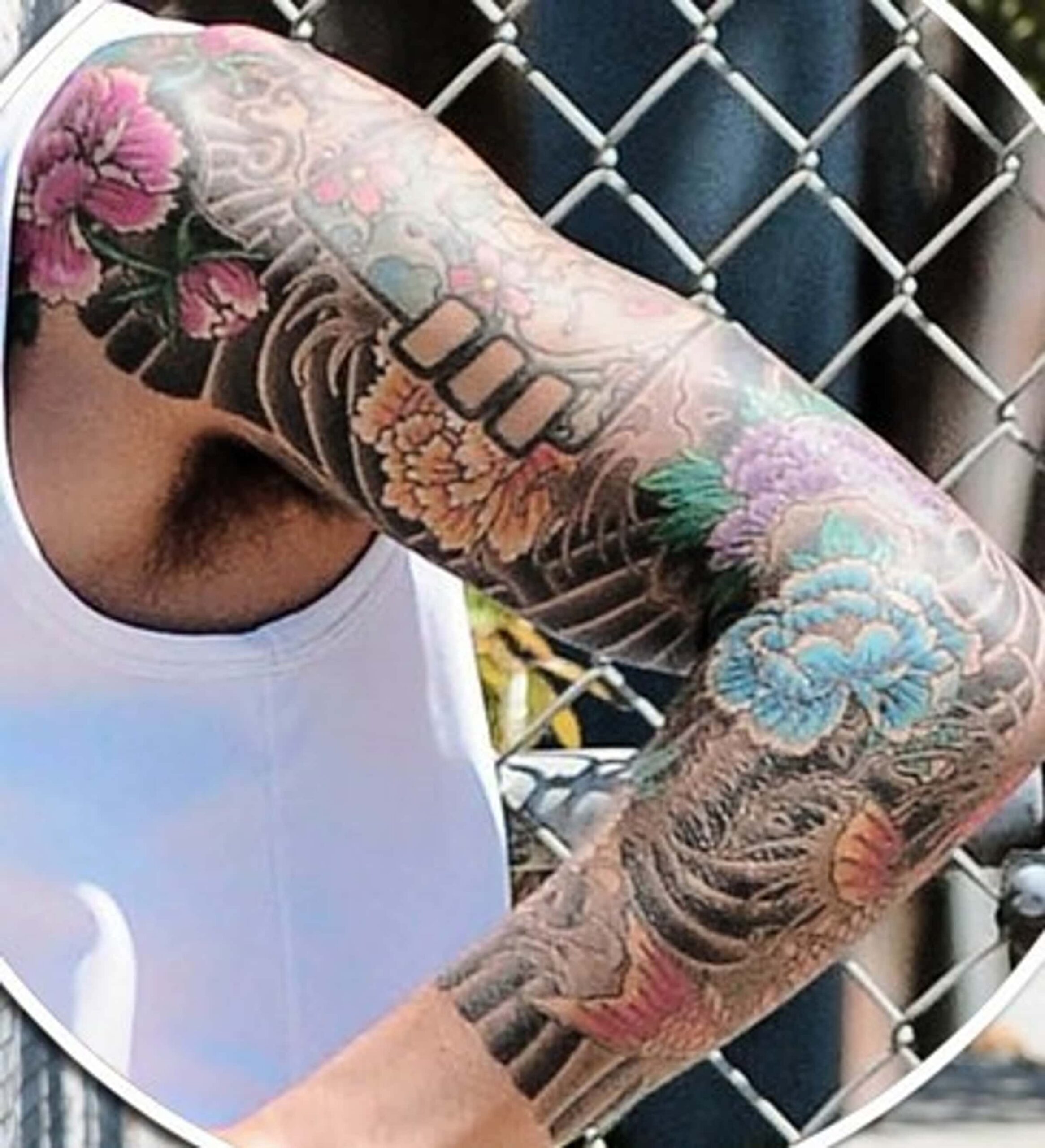 John Mayer’s floral and dragon-like left-arm sleeve tattoo