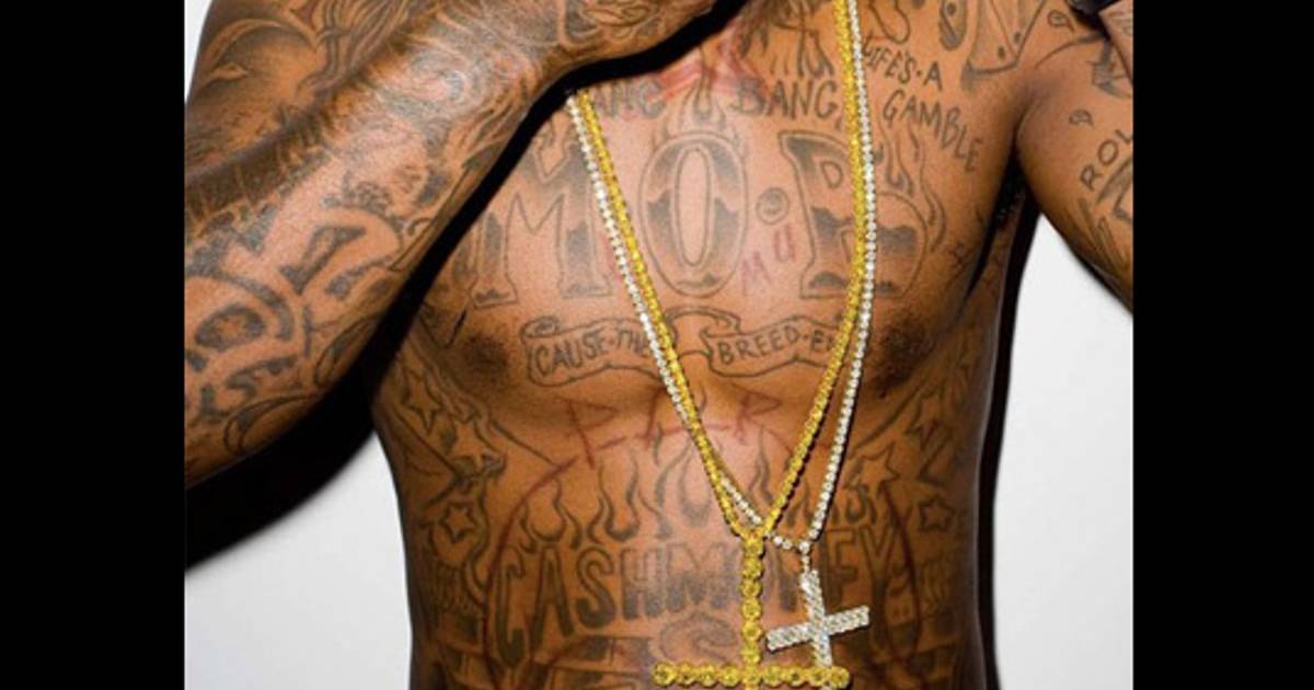 Lil Wayne’s tattooed chest and stomach, including M.O.B., Cash Money, Bang Bang and Life’s a Gamble lettering