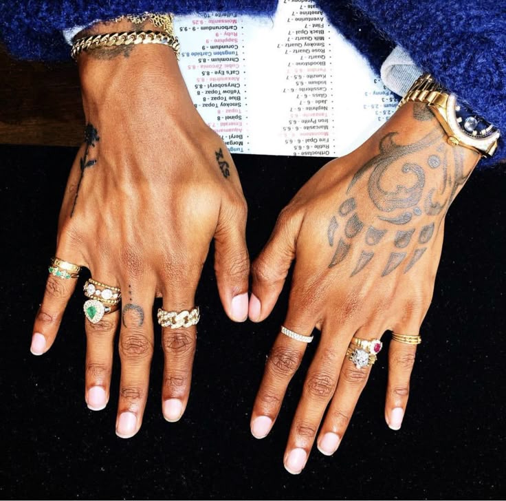 Close photograph of 6LACK’s tattooed hands, including the broad claw-like motif and smaller hand designs