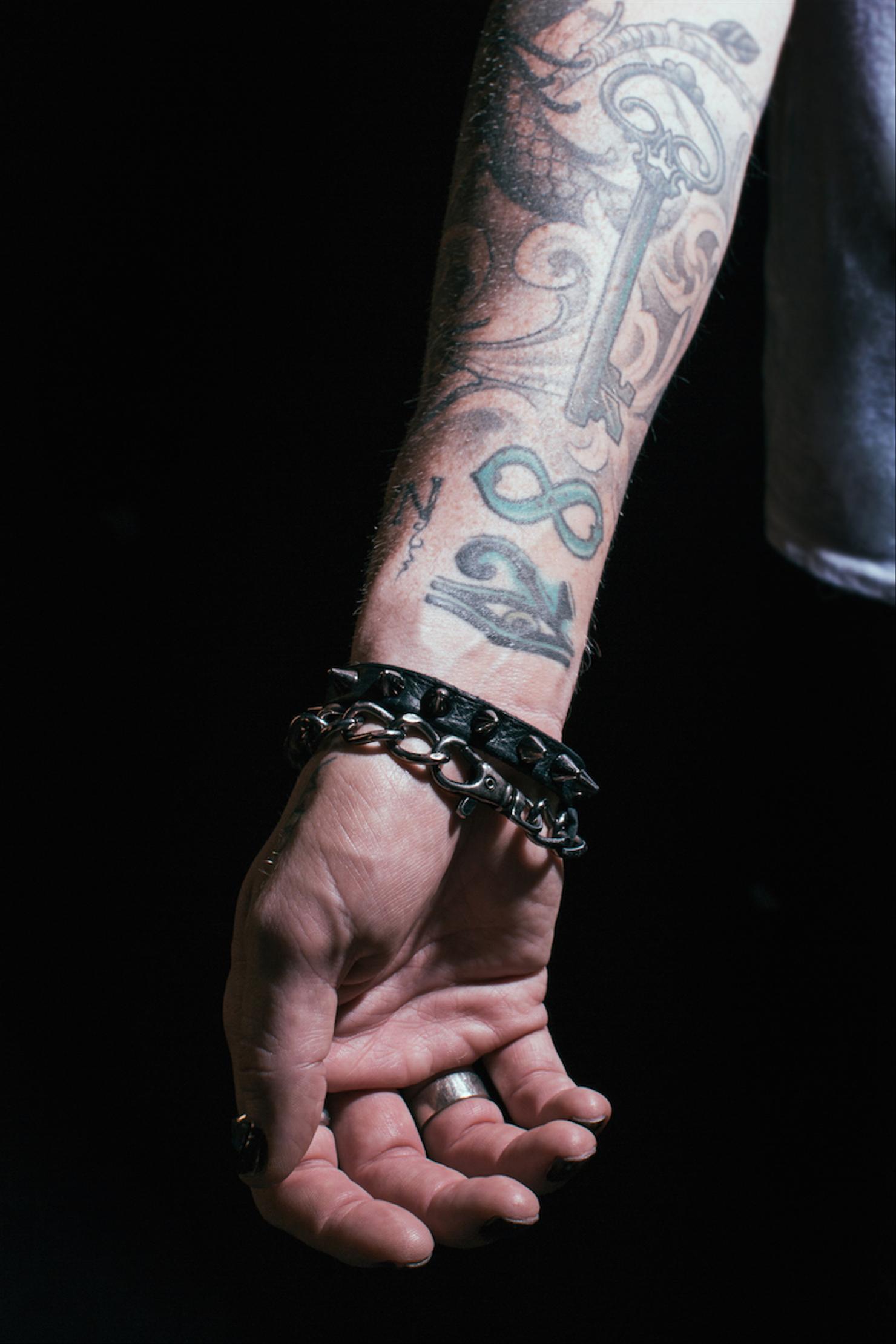 Adam Lambert infinity and key forearm tattoos