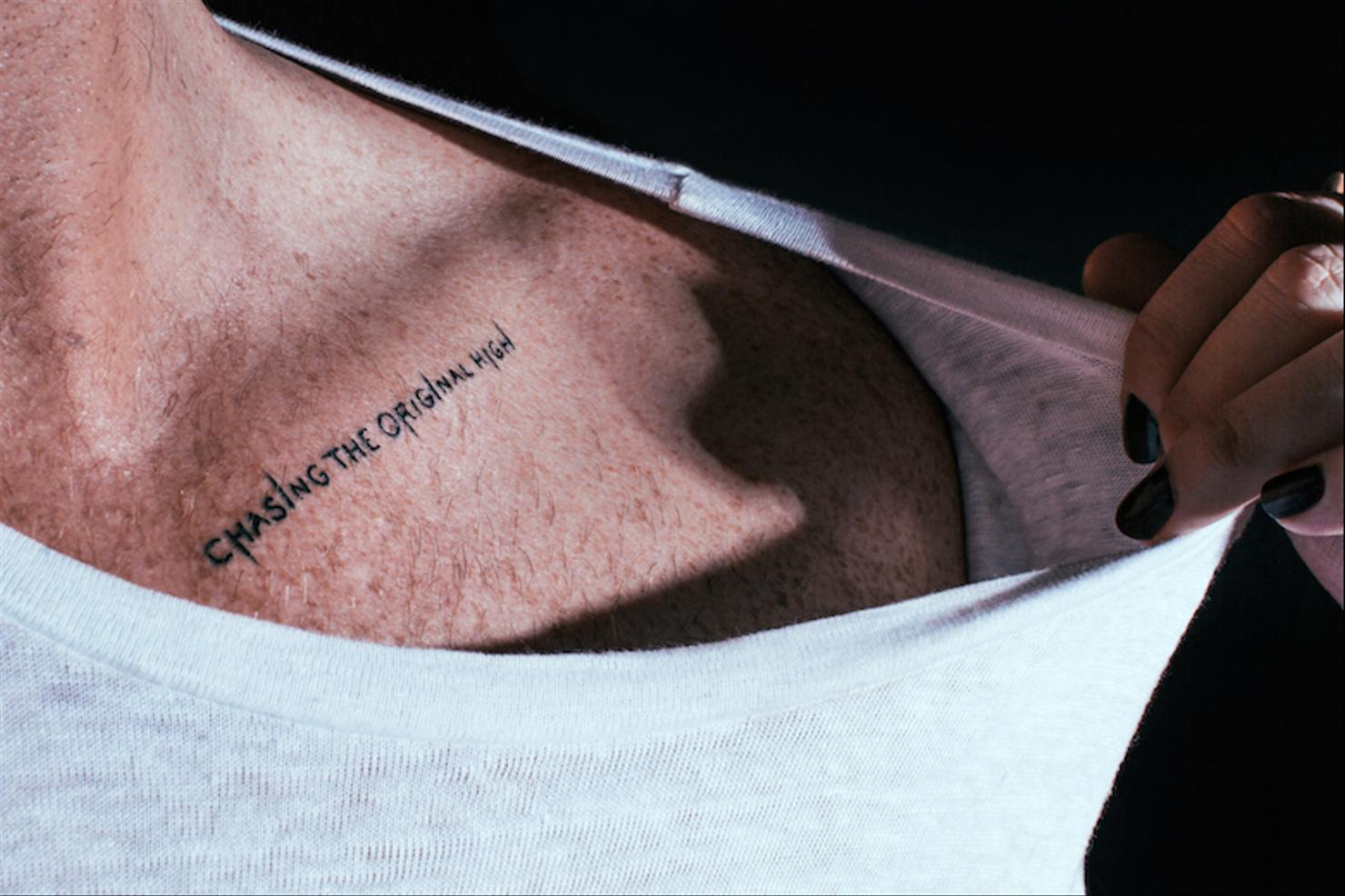 Adam Lambert mosaic and upside-down triangle arm tattoos