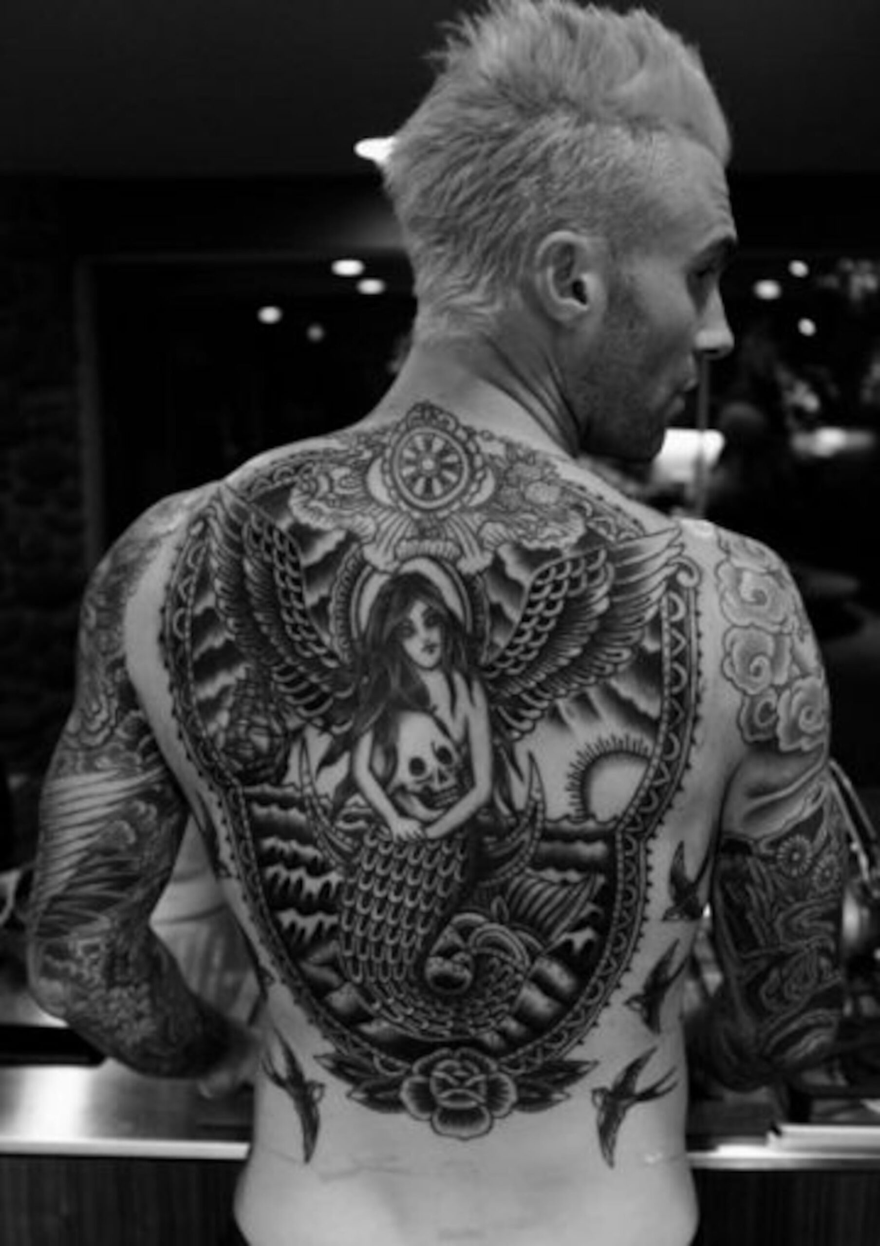 Adam Levine full-back mermaid tattoo with wings and skull