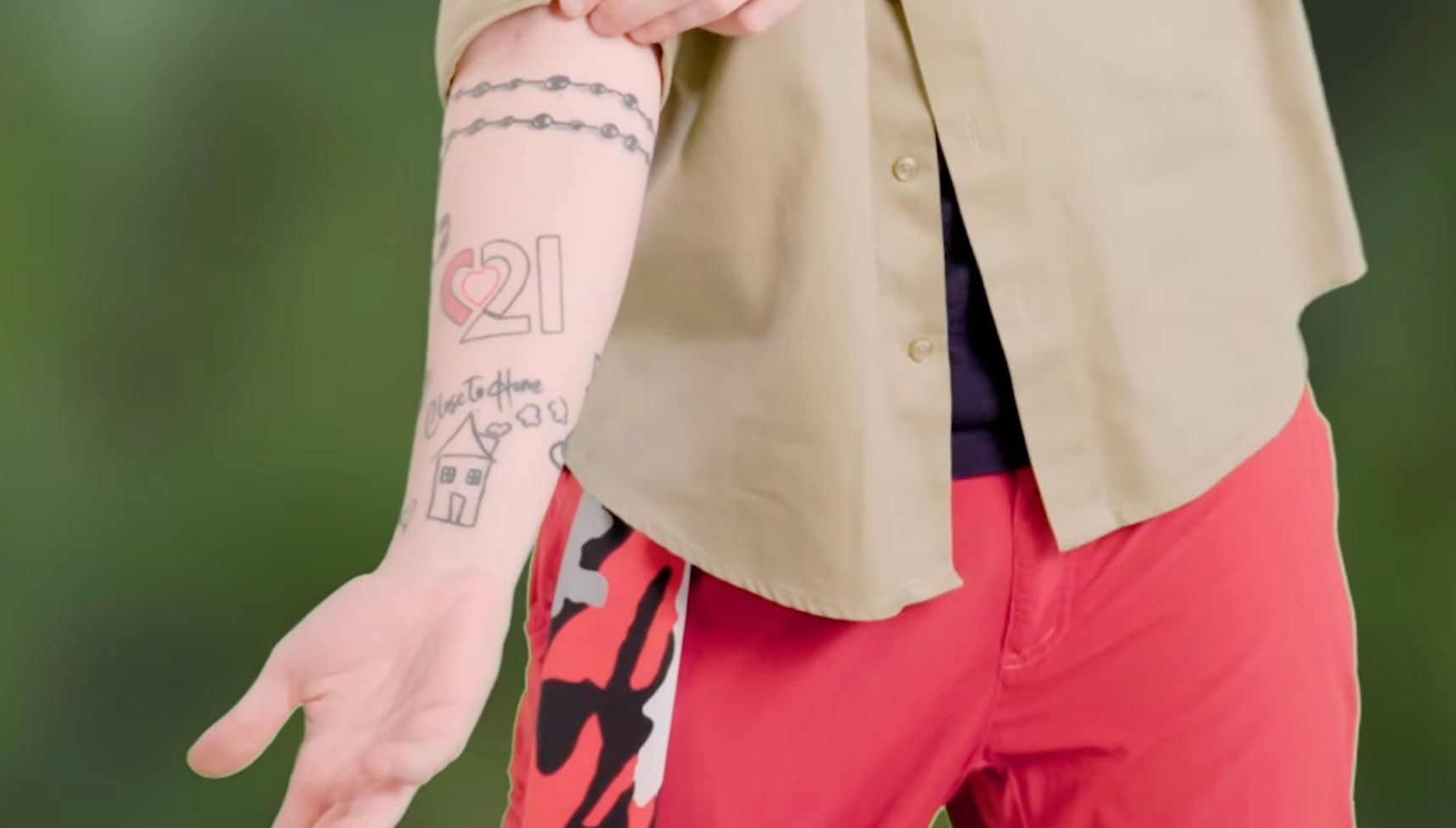 Aitch Close To Home arm tattoos including the 21 and house design