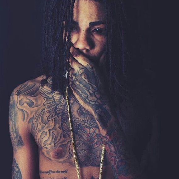 Alkaline chest and arm tattoos