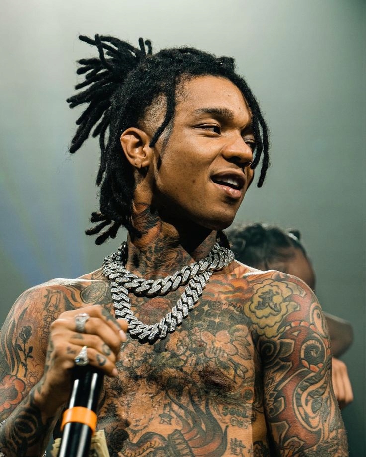 Swae Lee live performance with visible chest, neck and arm tattoos