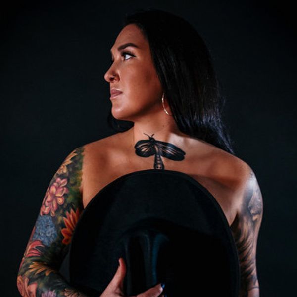 Allie Colleen dragonfly chest tattoo and floral sleeve tattoos