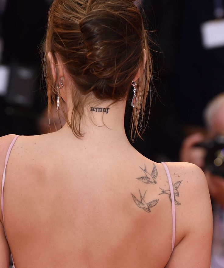 Dakota Johnson amor neck tattoo and bird tattoos