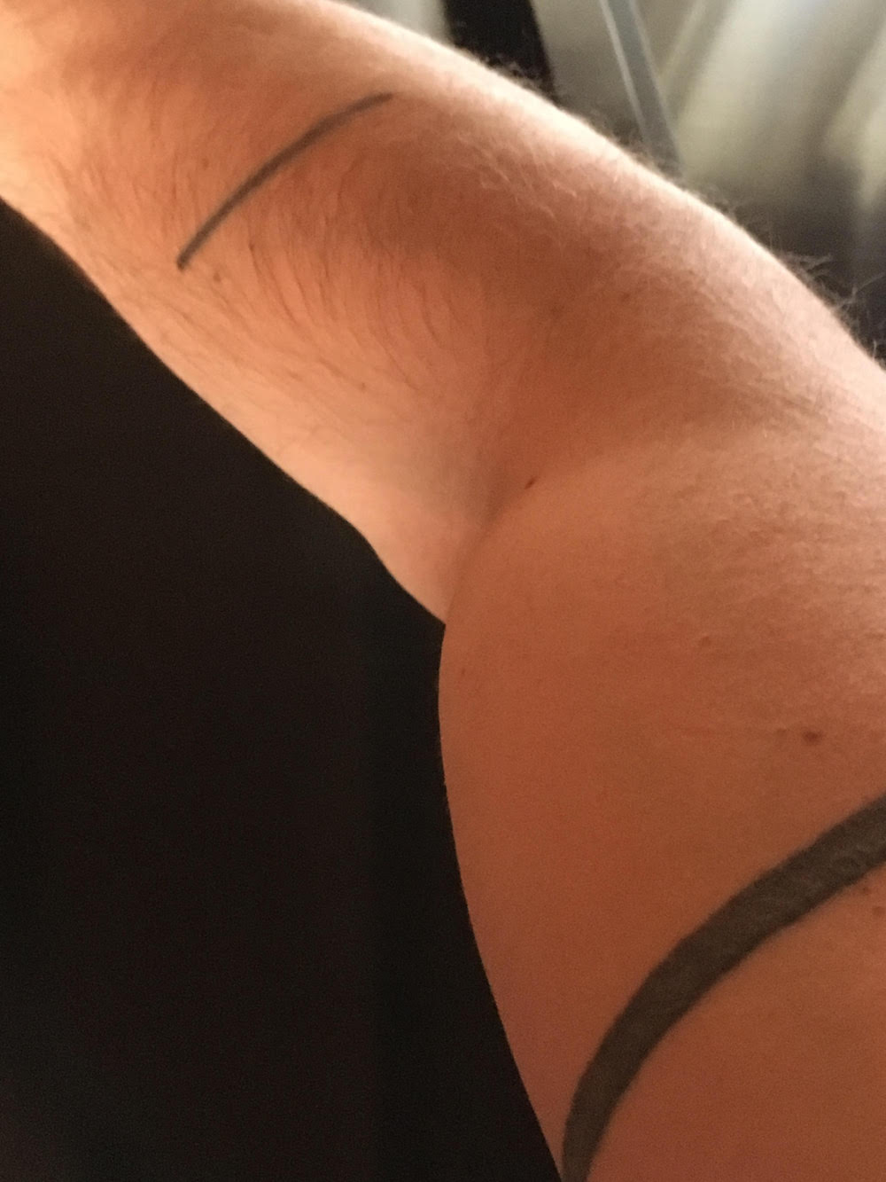 Andrew W.K. arm line tattoo close-up