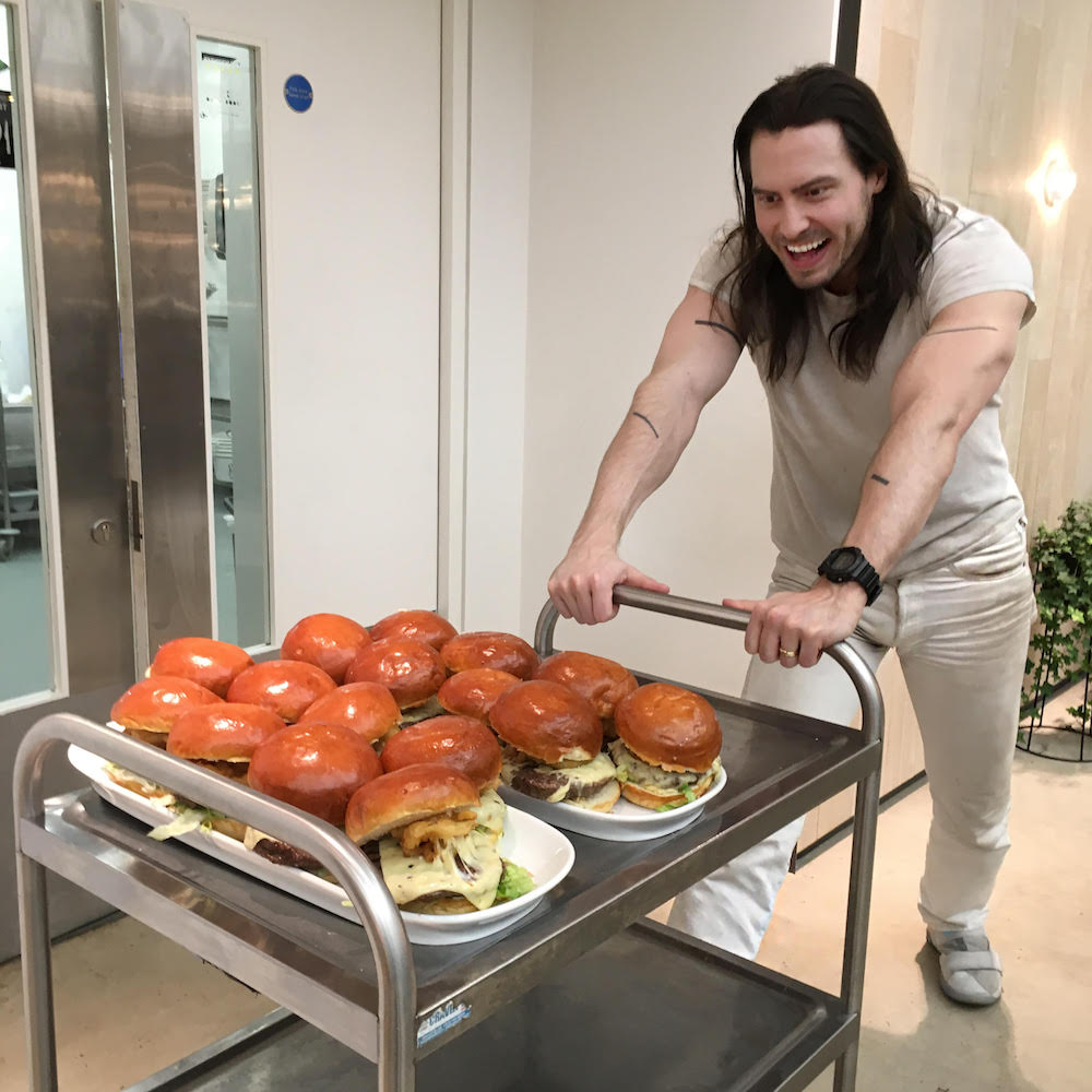 Andrew W.K. arm line tattoos while serving burgers