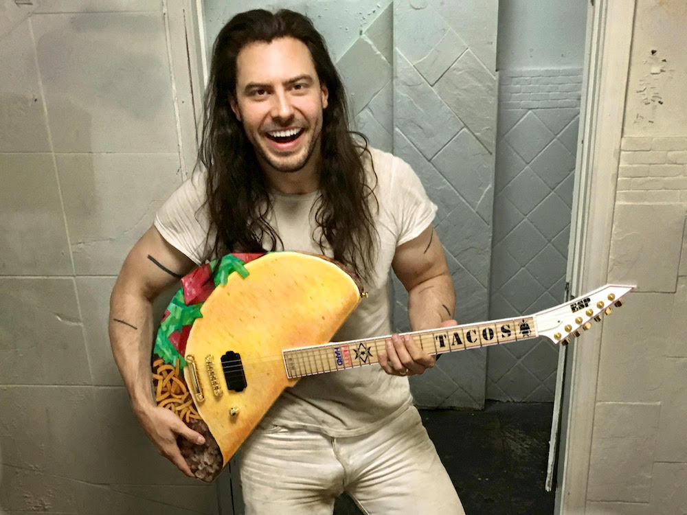 Andrew W.K. arm line tattoos with his taco guitar