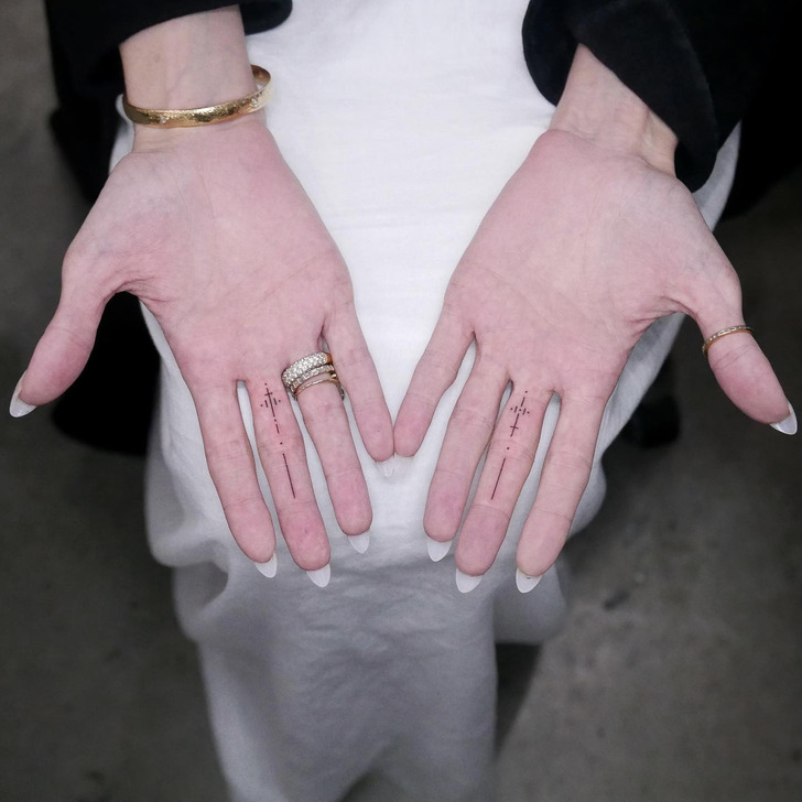 Angelina Jolie matching middle-finger tattoos