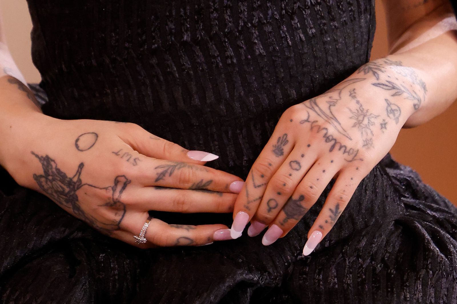 Ariana Grande vine and daisy hand tattoos