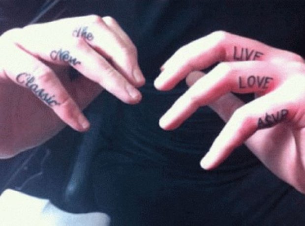 A$AP Rocky showing documented finger lettering tattoos