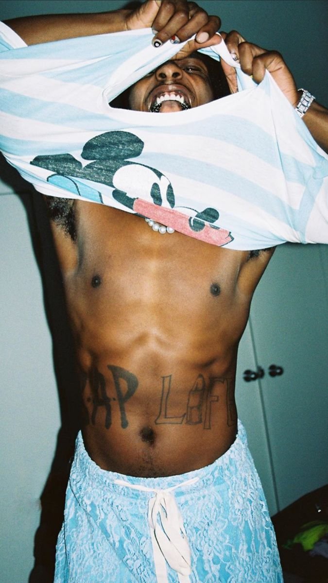 A$AP Rocky showing the A$AP LIFE abdomen tattoo