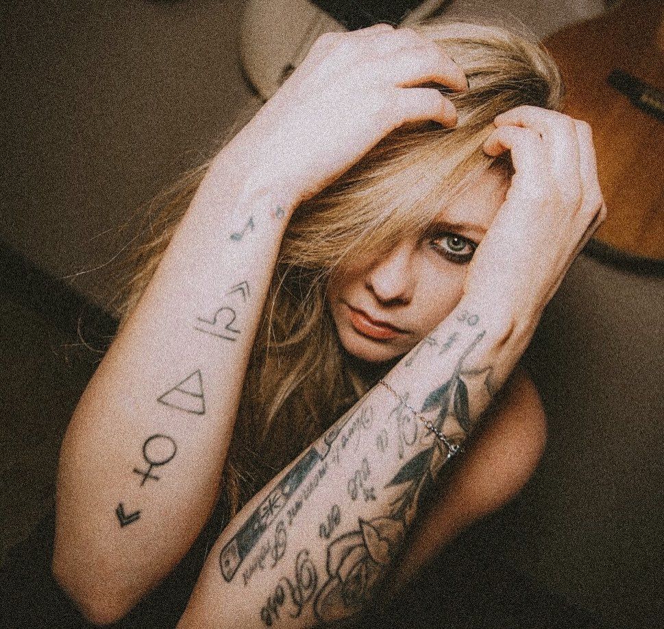Avril Lavigne forearm symbols and tattoos