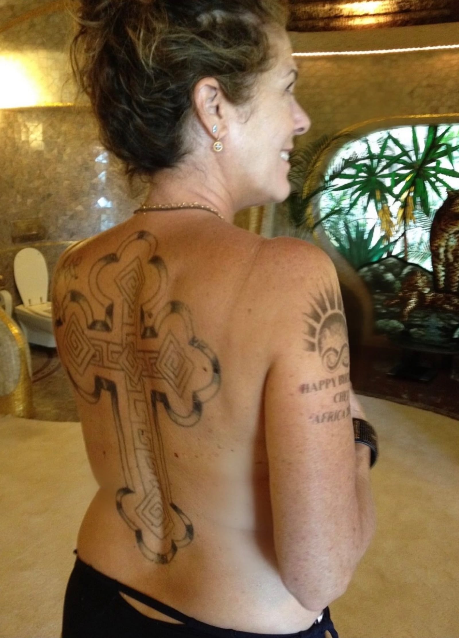 Rita Wilson back cross tattoo