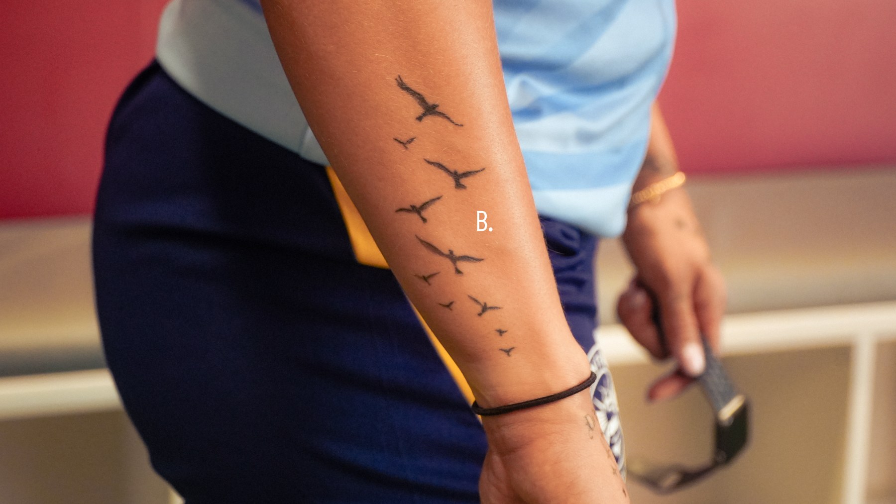 Becca Teale birds tattoo on the side of her arm