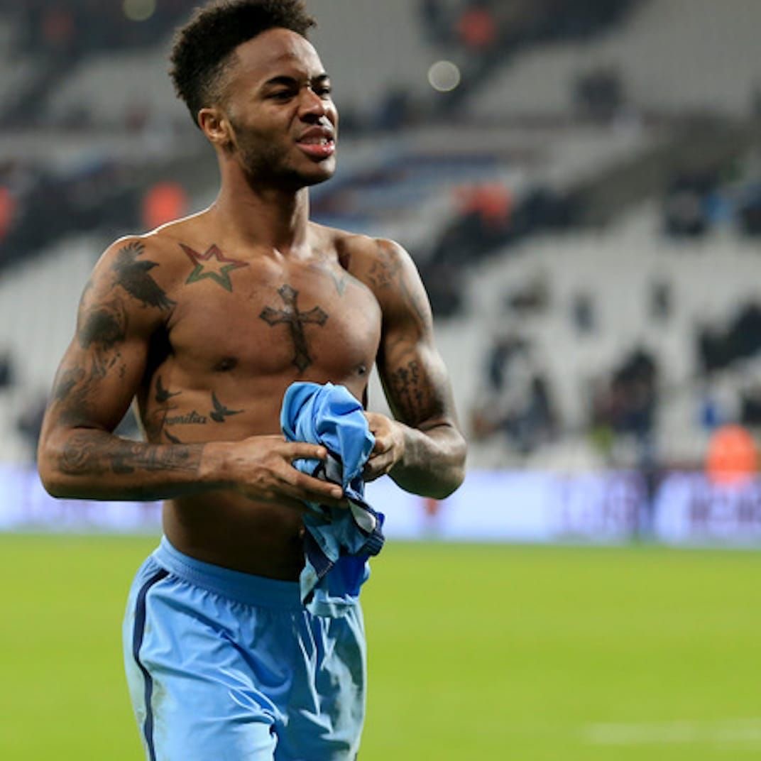 Raheem Sterling tattoos: different high-resolution shirtless celebration photo showing chest and shoulder ink