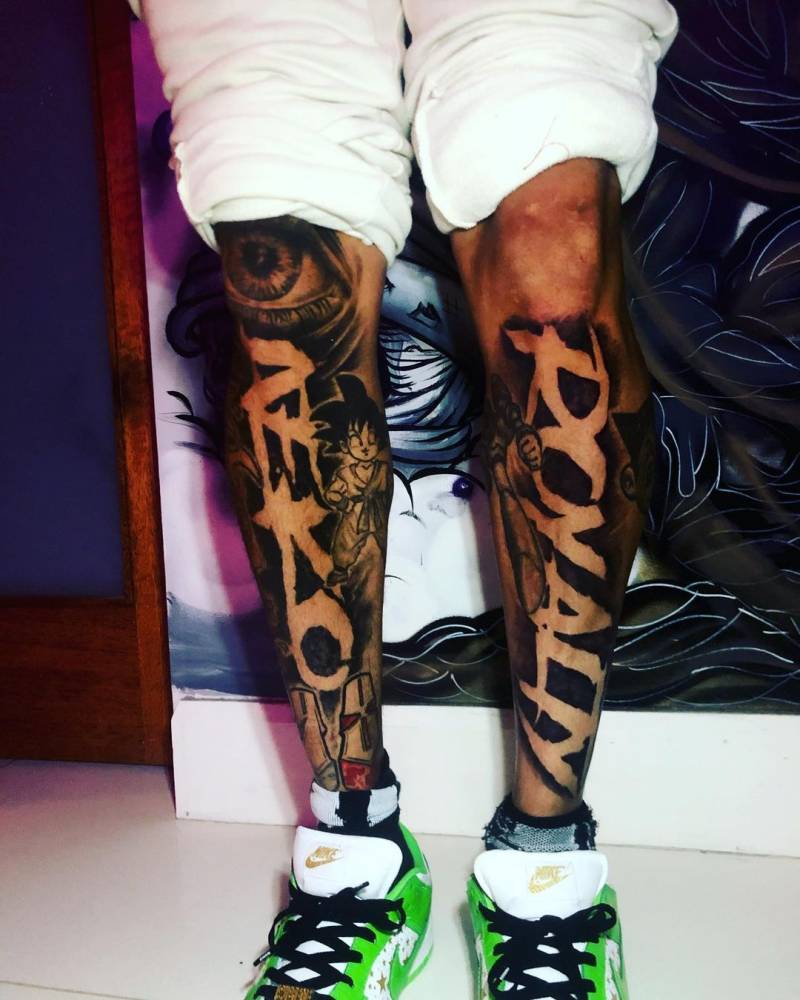Chris Brown's Royalty lettering and illustrated tattoo on one shin