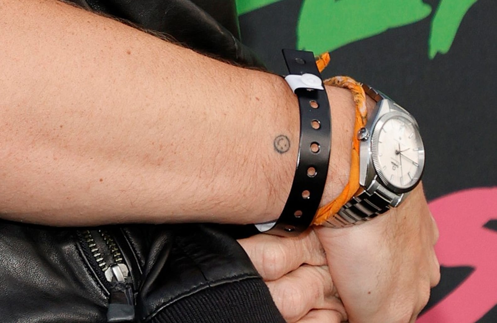 Chase Stokes smiley wrist tattoo