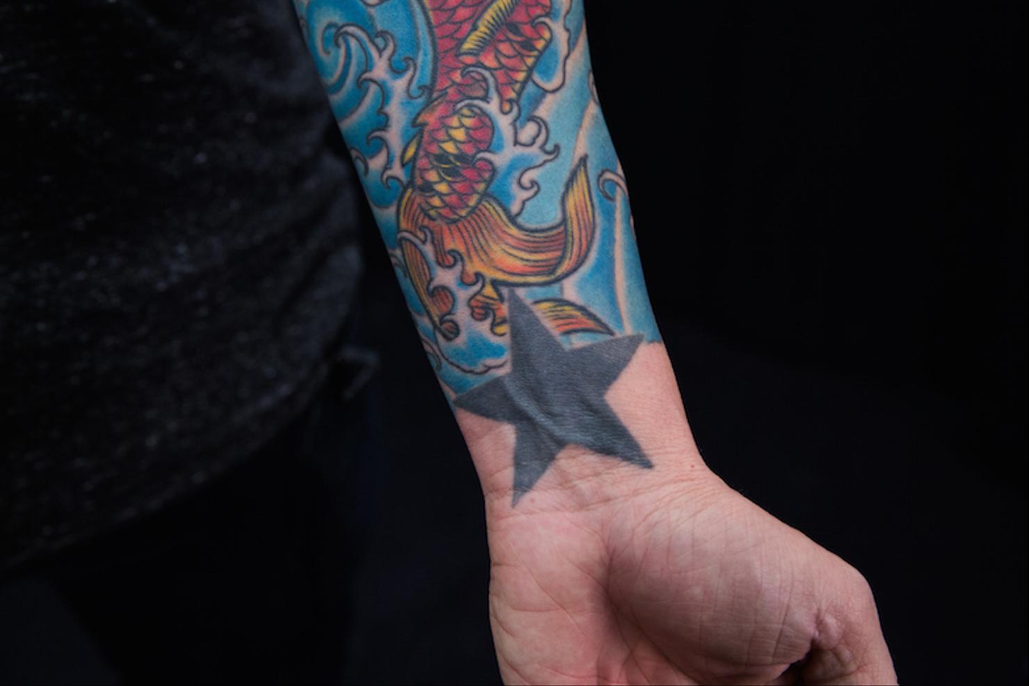 Chris Carrabba koi fish and star wrist tattoos