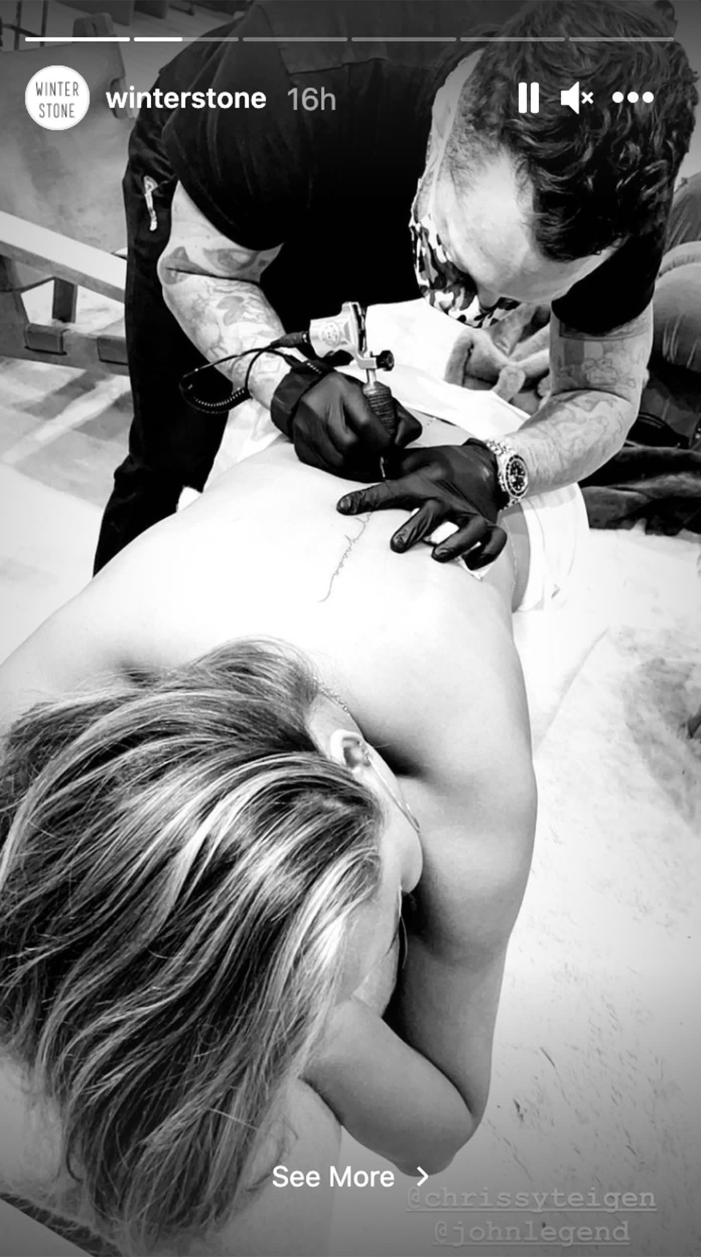 Chrissy Teigen Ooh Laa spine tattoo