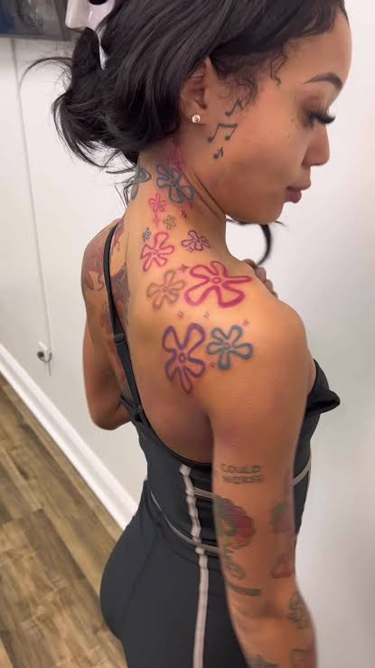 Coi Leray koi and flower tattoos