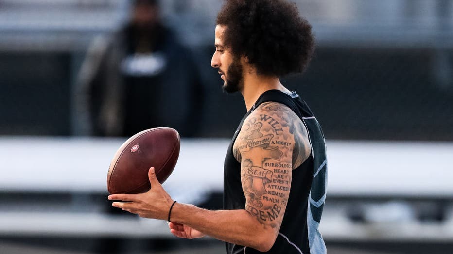 Colin Kaepernick script tattoos on his arm