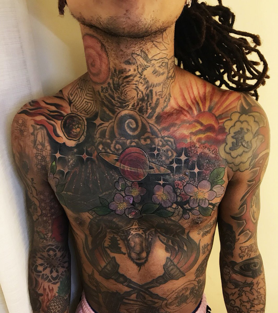 Swae Lee cosmic chest tattoo with planets, flowers and space imagery