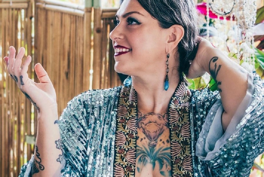 Danielle Colby showing hand and arm tattoos