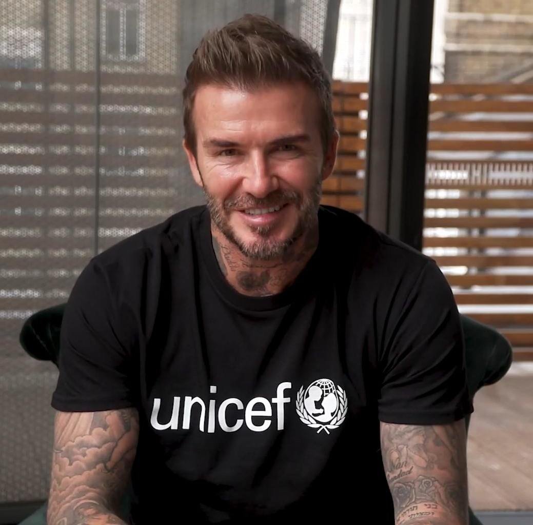 David Beckham with visible neck and arm tattoos during a UNICEF appearance
