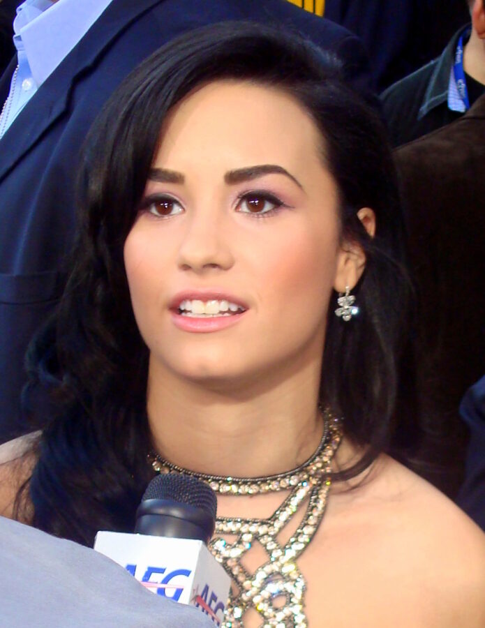 Demi Lovato showing the chest and torso tattoo area