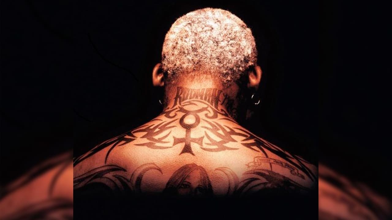 Dennis Rodman showing his upper-back tribal tattoos and RODMAN lettering