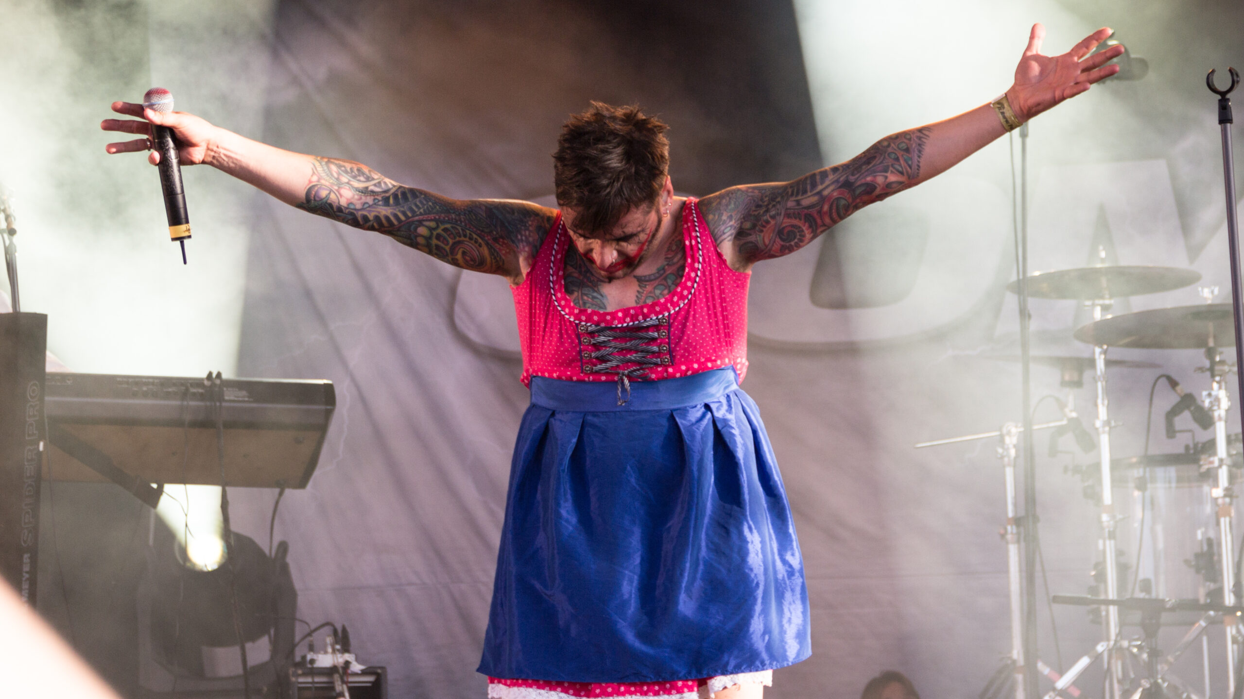 Dero Goi sleeve and chest tattoos, showing how the blackwork flows across his upper body.