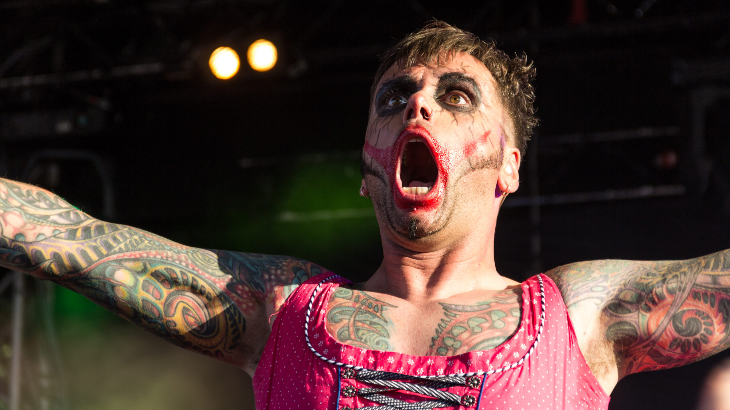 Dero Goi tattoos across both arms and chest during an Oomph! performance.