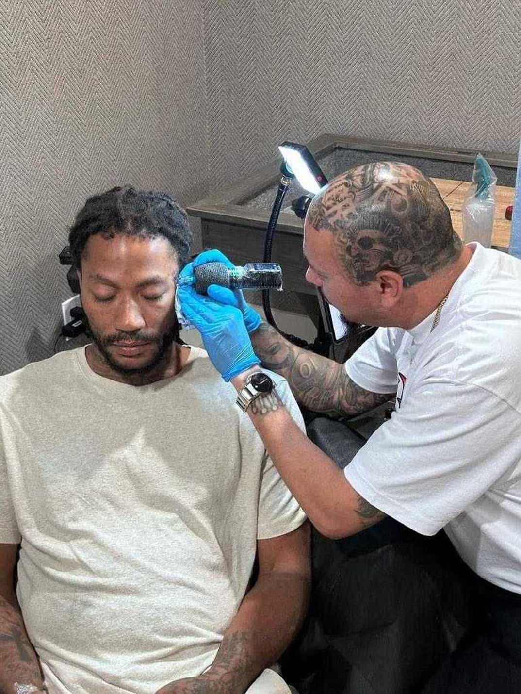 Derrick Rose getting his new face tattoos from Killer Tattoos